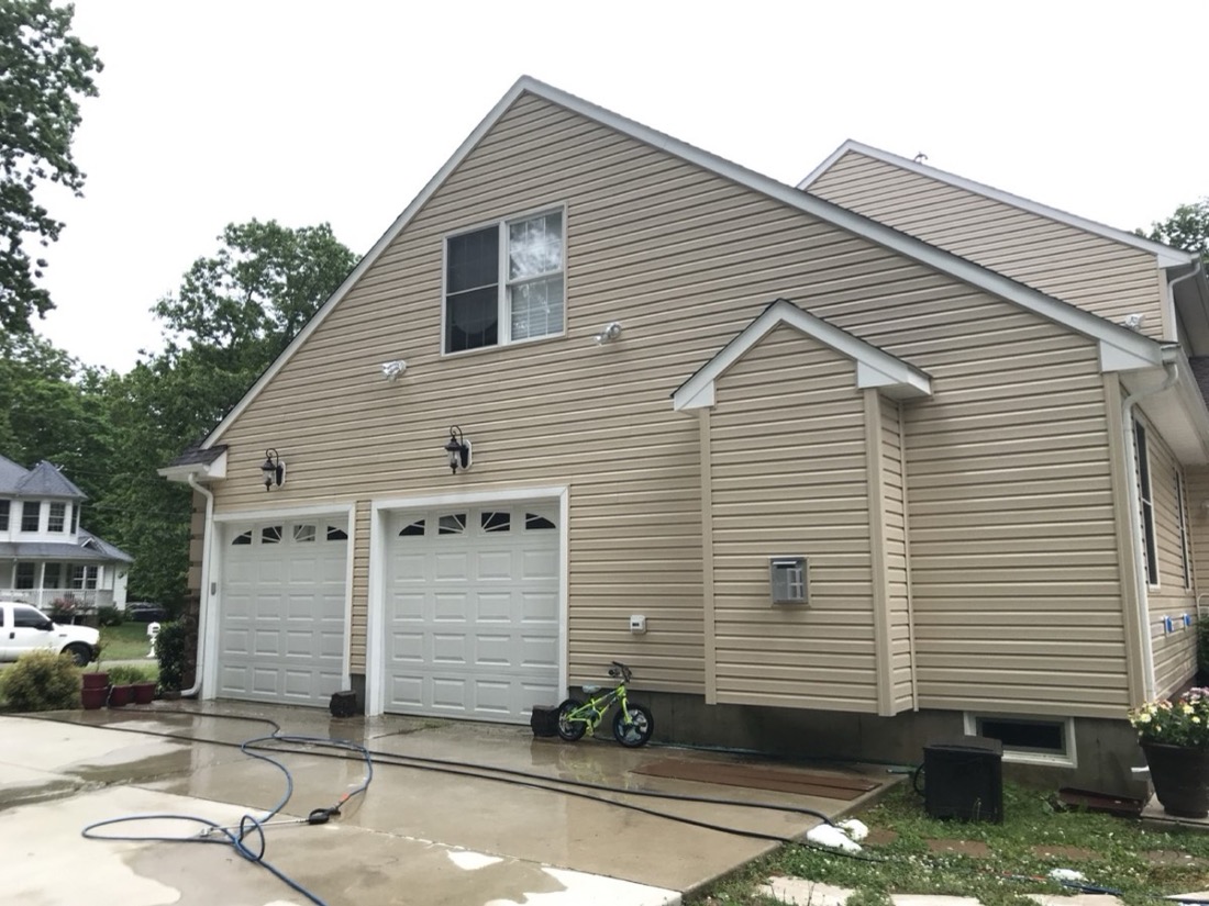 The same garage and upper siding after Pressure Tech exterior cleaning