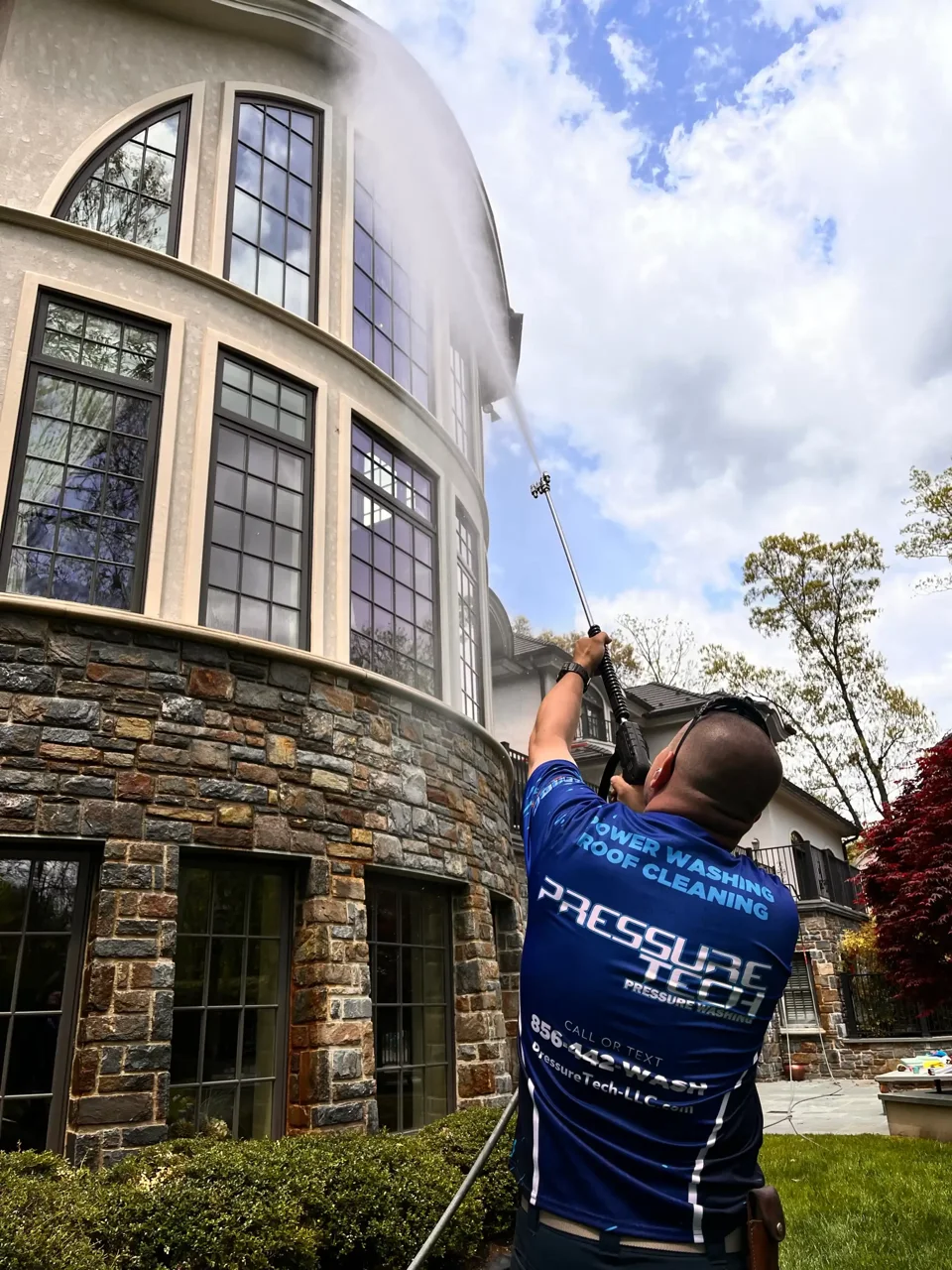 Pressure Tech technician cleaning the exterior of a residential property
