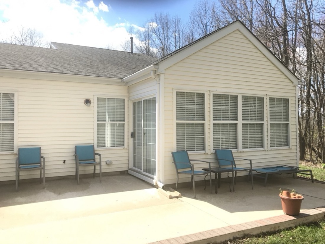 The same house siding and patio exterior after Pressure Tech cleaning